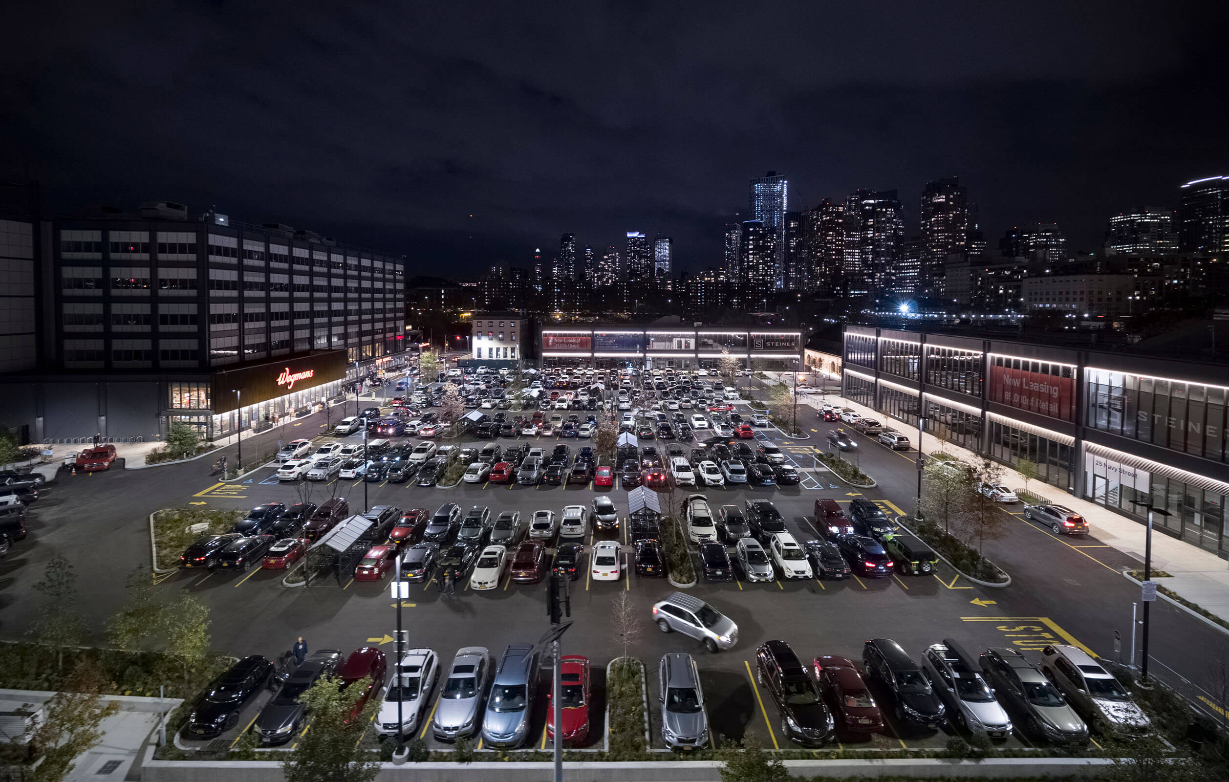 Aerial night view of parking area next to Wegmans supermarket in Brooklyn