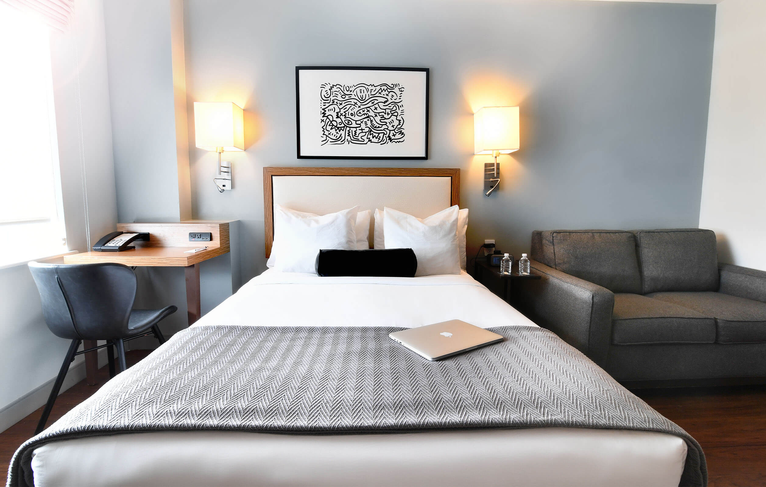 Elegant bed and lighting inside hotel room at the Edge Hotel