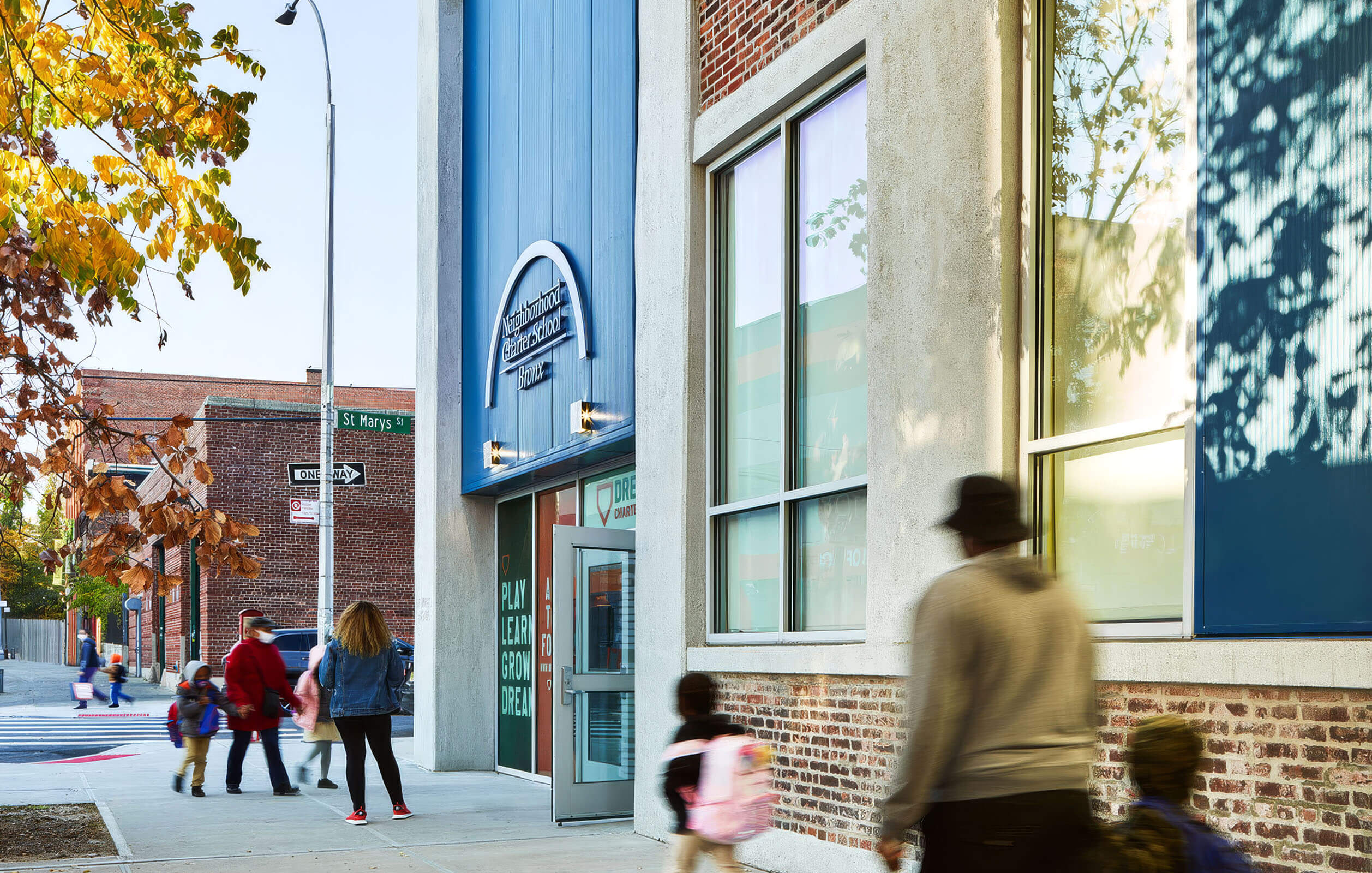 Mother and child walking into the public charter in the Bronx known as the Neighborhood Charter School