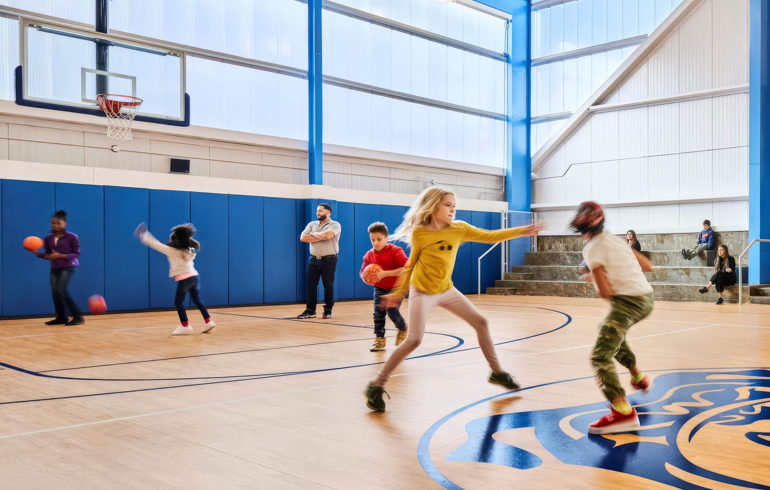 Students playing basketball in the gym at the new Neighborhood Charter School in the Bronx