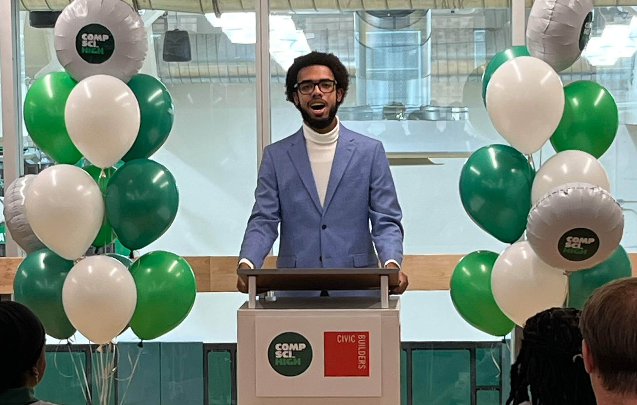 Student speaking behind a podium at the ribbon cutting ceremony for the grand opening of Comp Sci High in the South Bronx