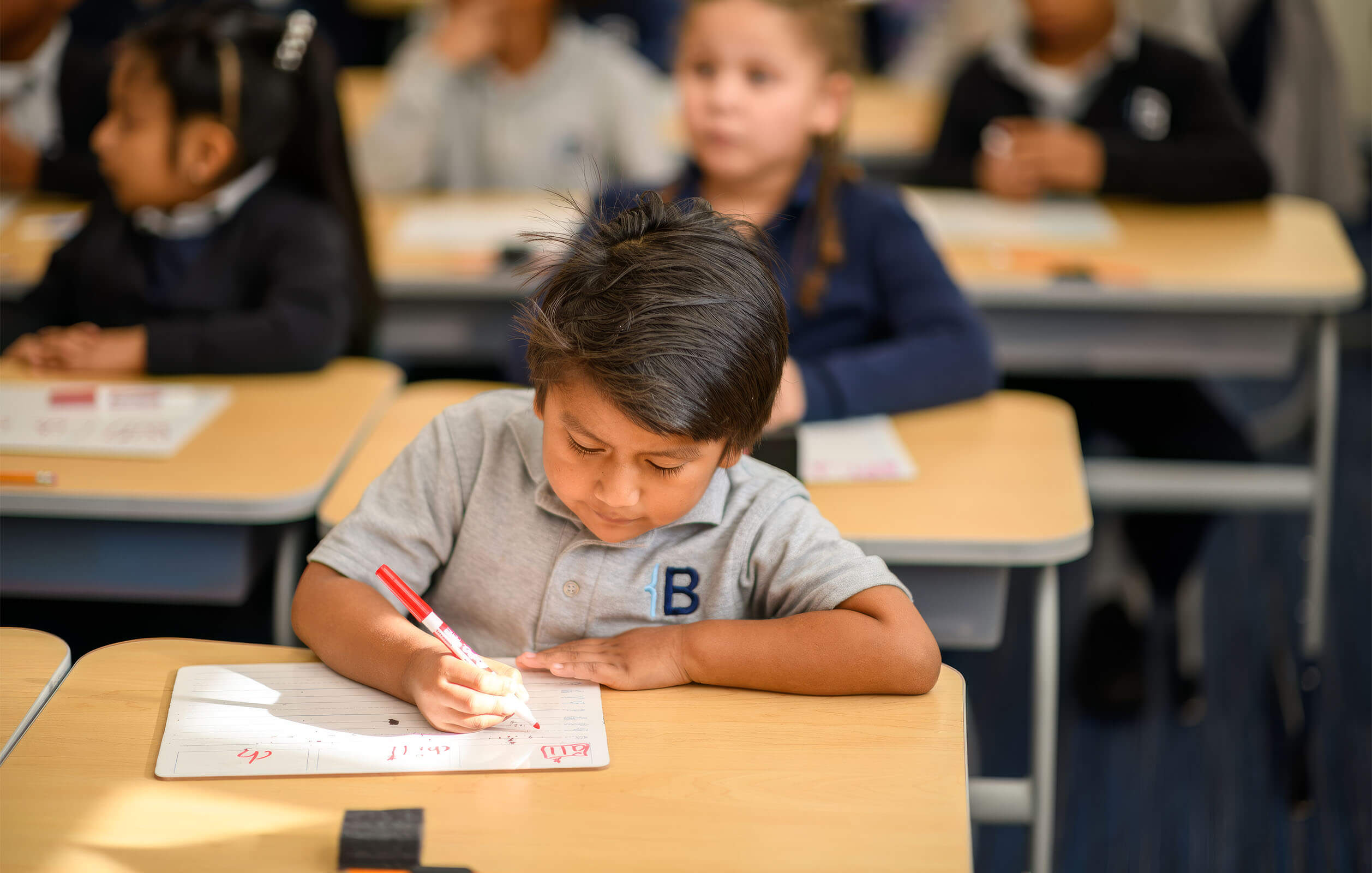 A student working in a classroom at the Bold Charter School