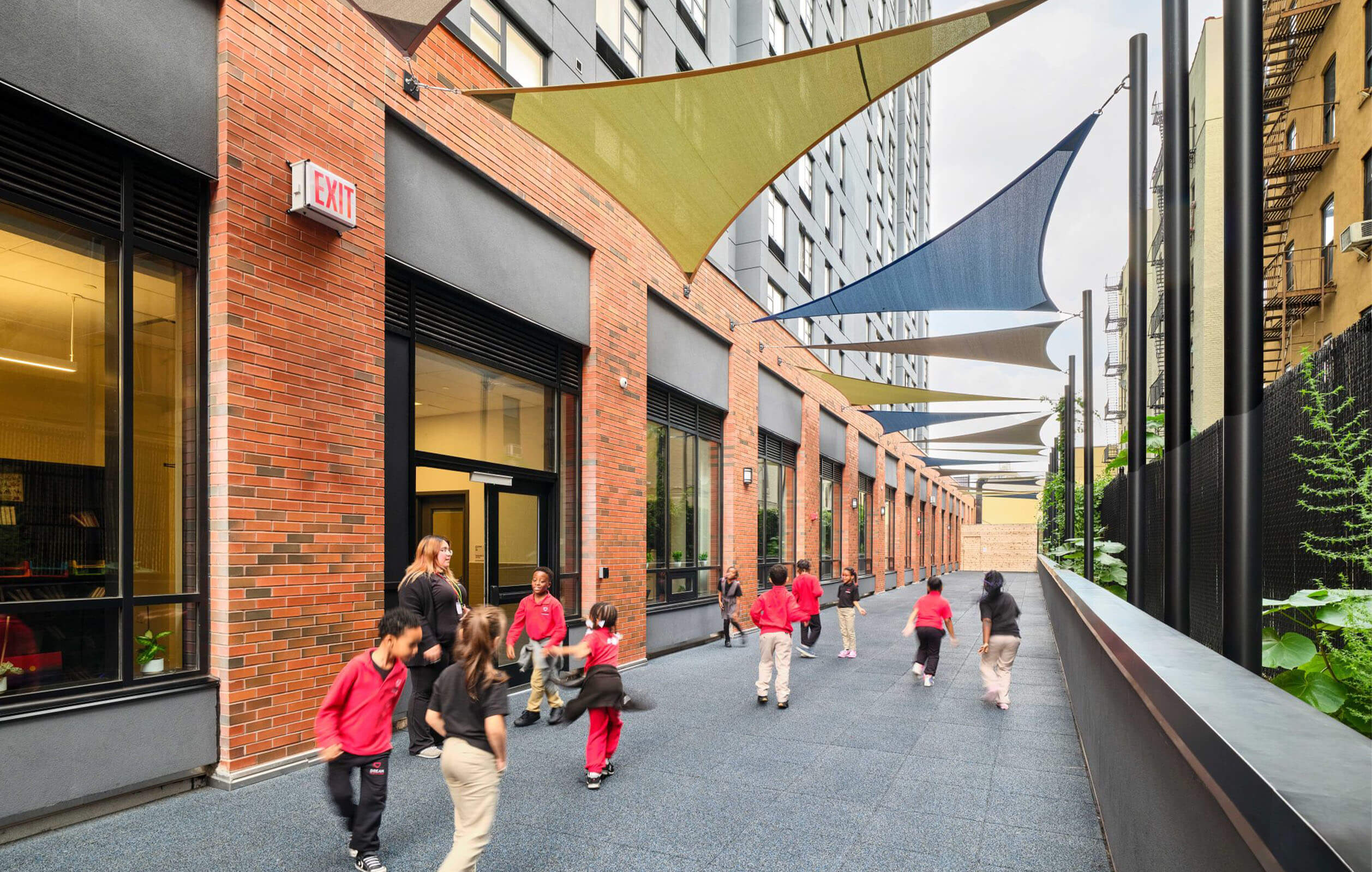 Students walking next to a new public charter school in the South Bronx named DREAM Highbridge Charter School