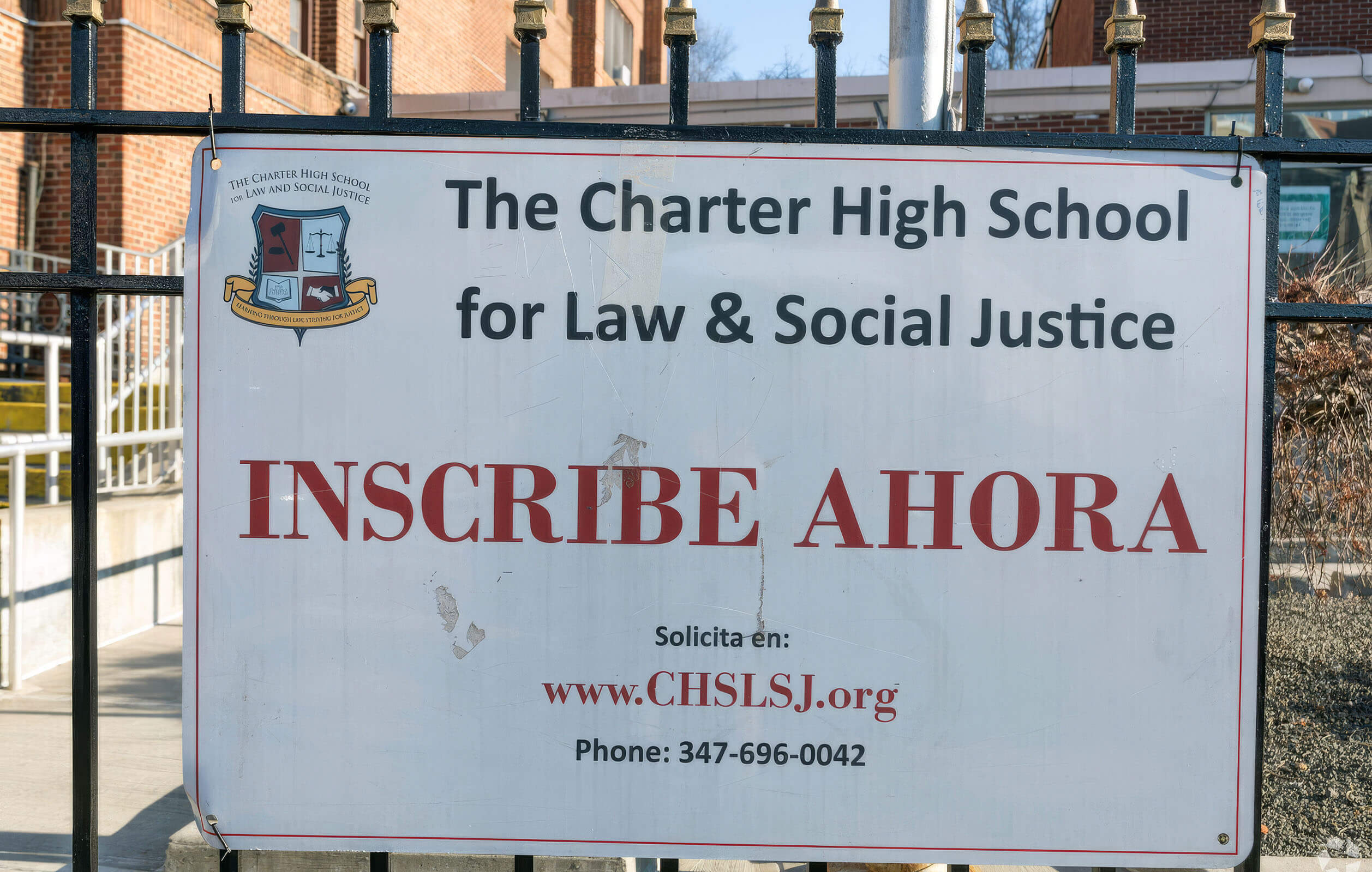 Sign for the Charter High School for Law & Social Justice at the entrance to the school