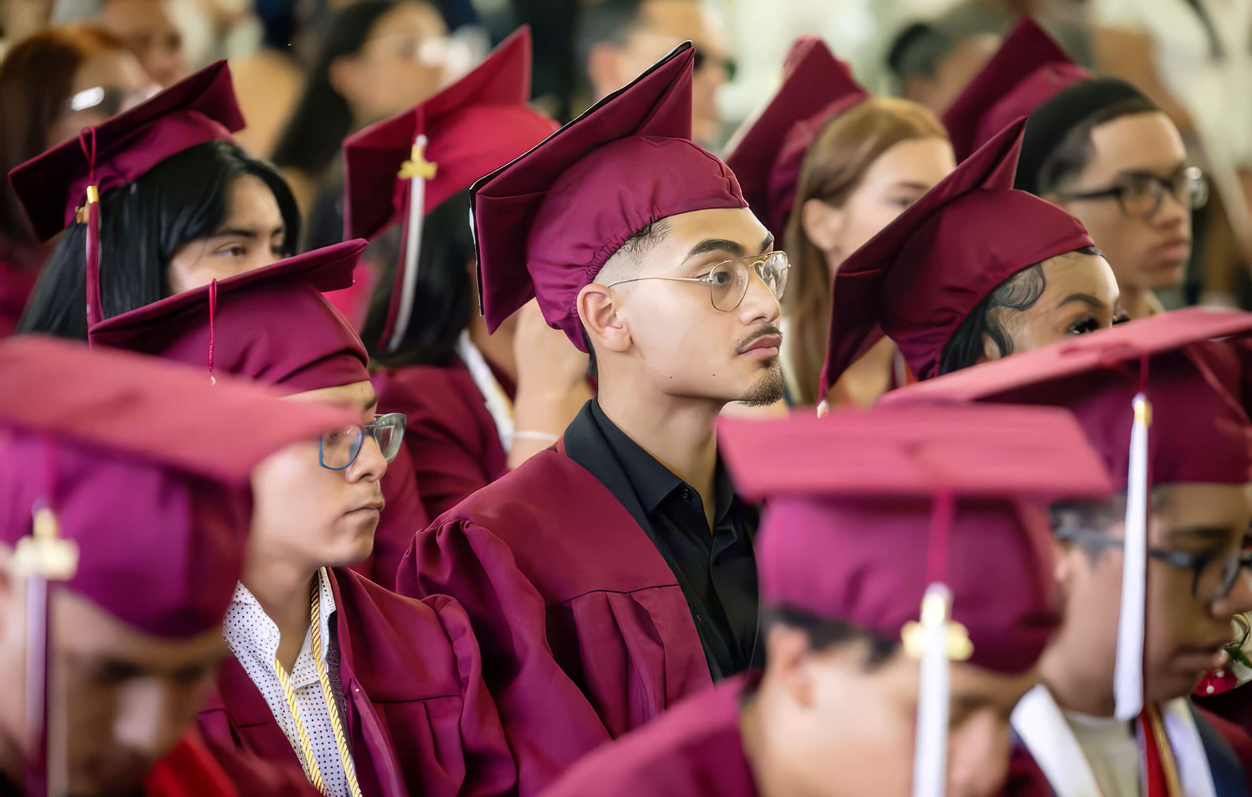 Students in graduation gowns at the graduation ceremony for the Charter High School for Law and Social Justice