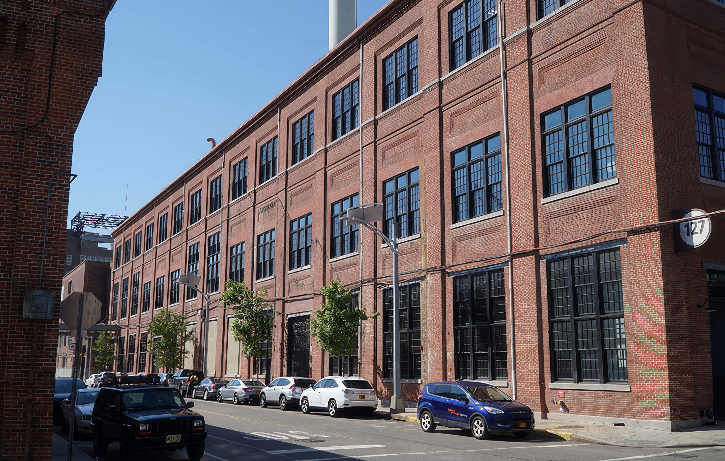 Cars parked alongside Building 127 in the Brooklyn Navy Yard