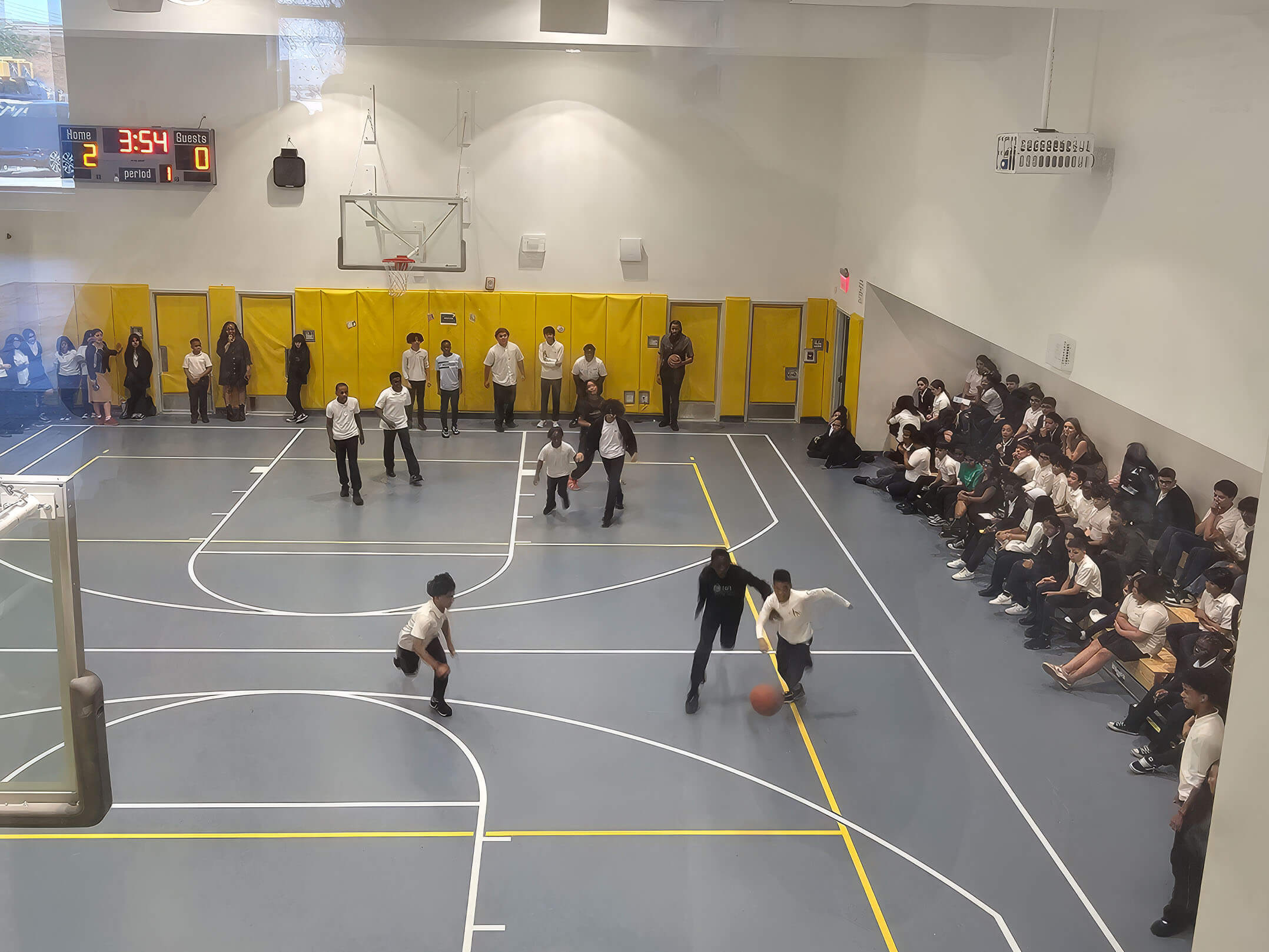 Overhead view of students playing in gym at Cyrpress Hills Ascend Middle School in Brooklyn