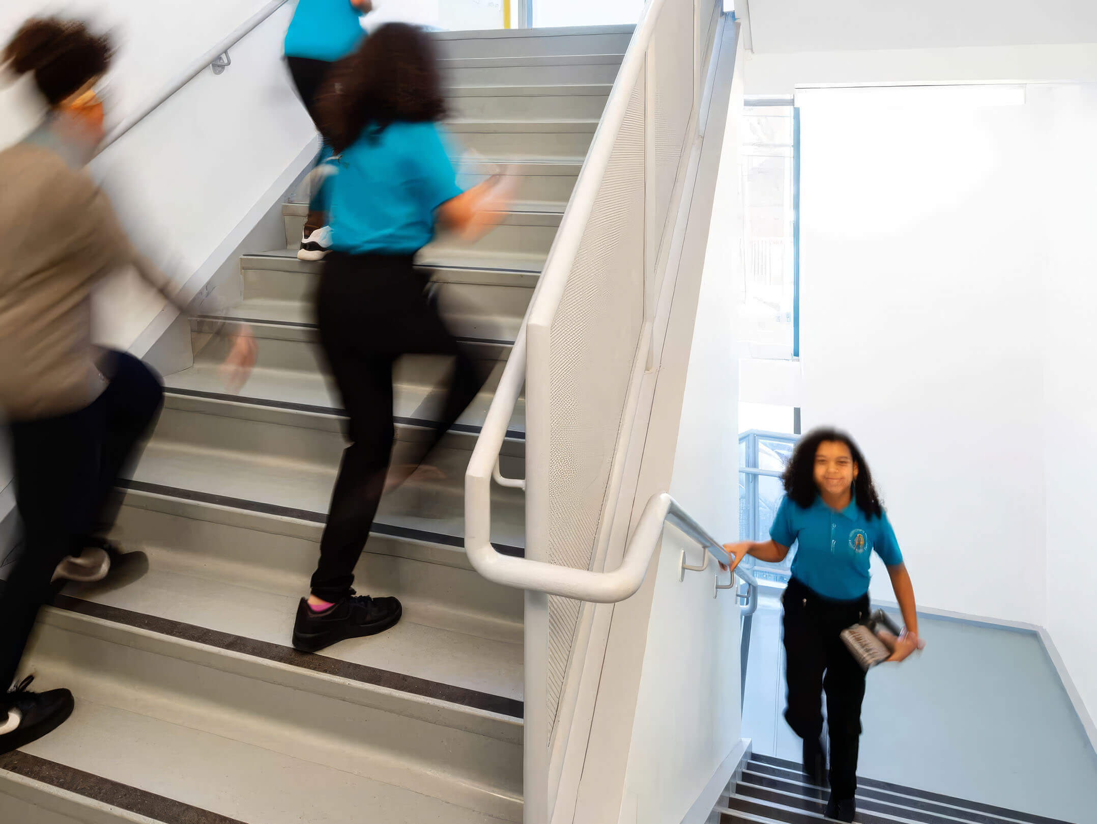 Students walking up the stairs at the First Linden Middle School run by Achievement First