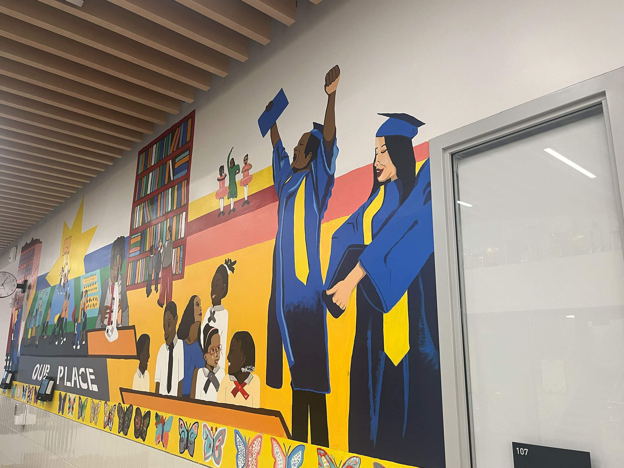 Murals showing students graduating on the walls of the Harlem Children's Zone Promise Acadamy II