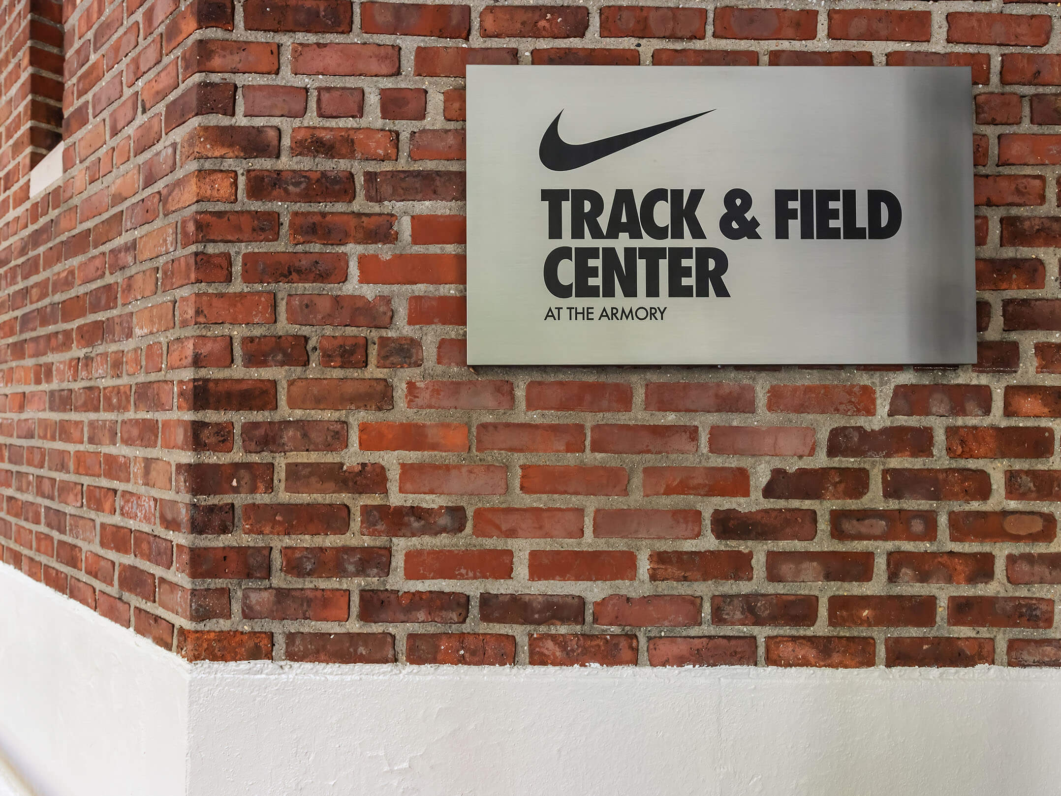 Sign with Nike logo at the entrance of the Nike Track & Field Center at the Amory