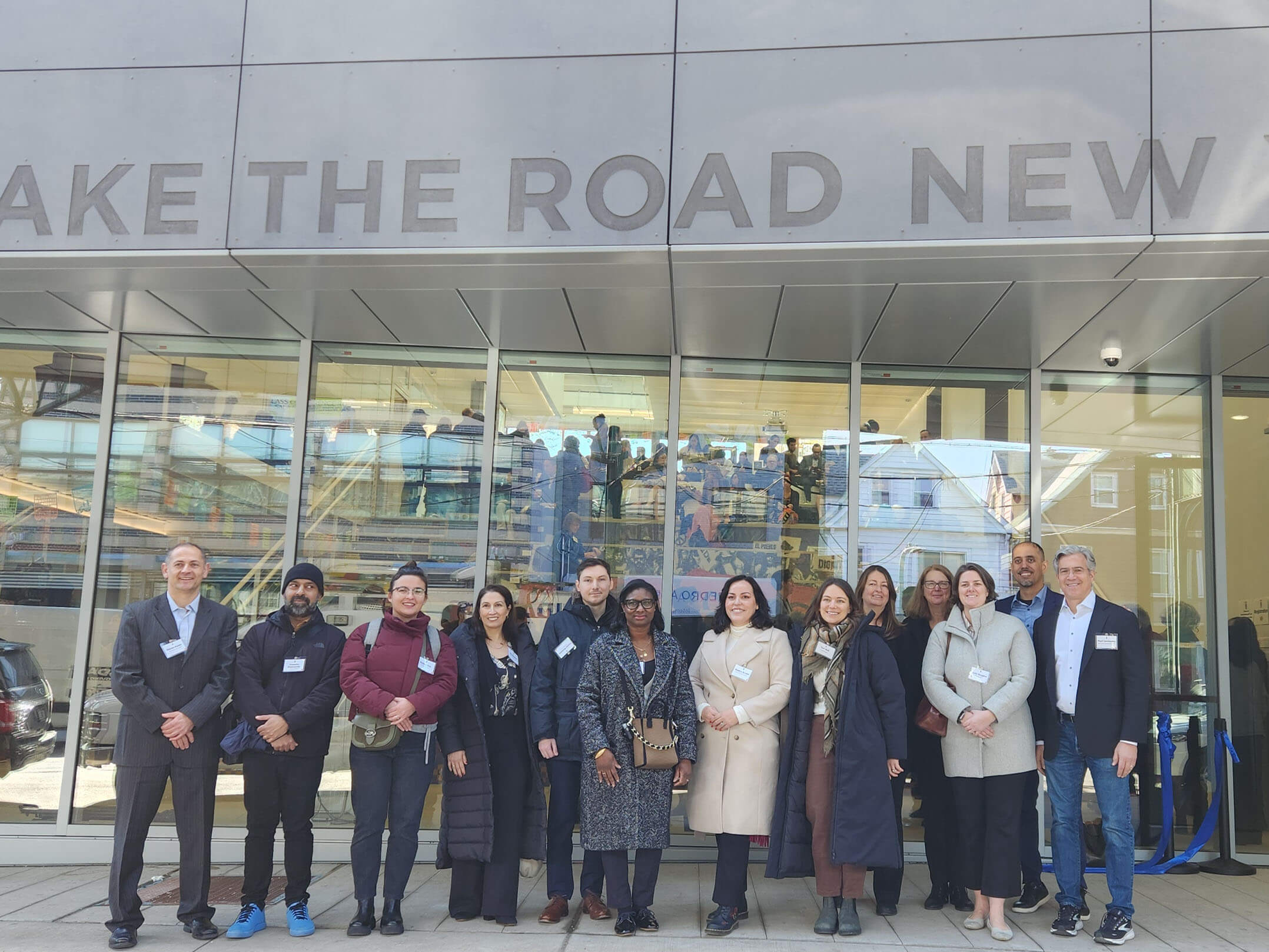 New Markets Tax Credit team posing in front of Make the Road New York's new community center in Queens