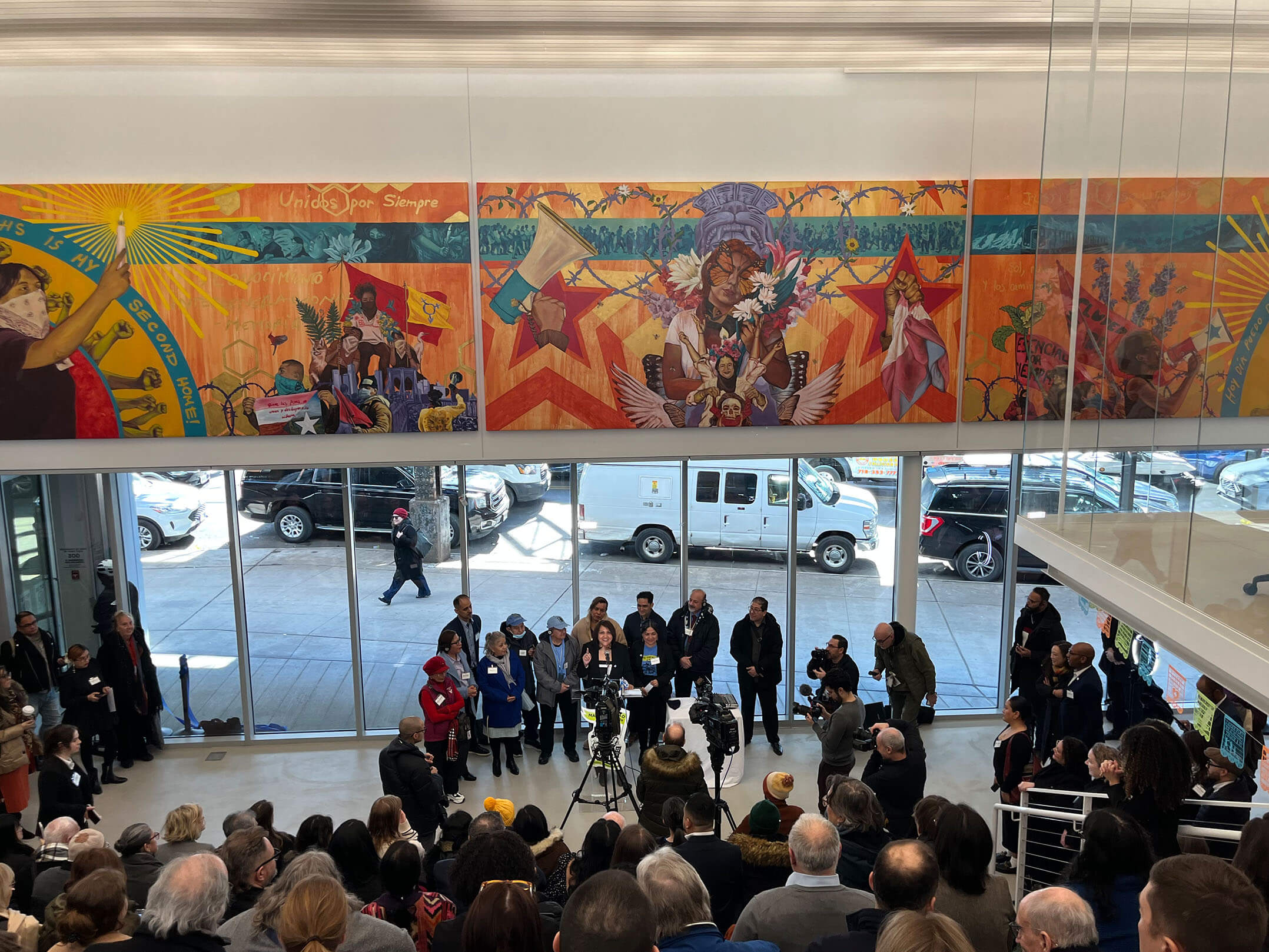 People gathering for the ribbon cutting ceremony celebrating the grand opening of Make the Road New York's new community center in Queens