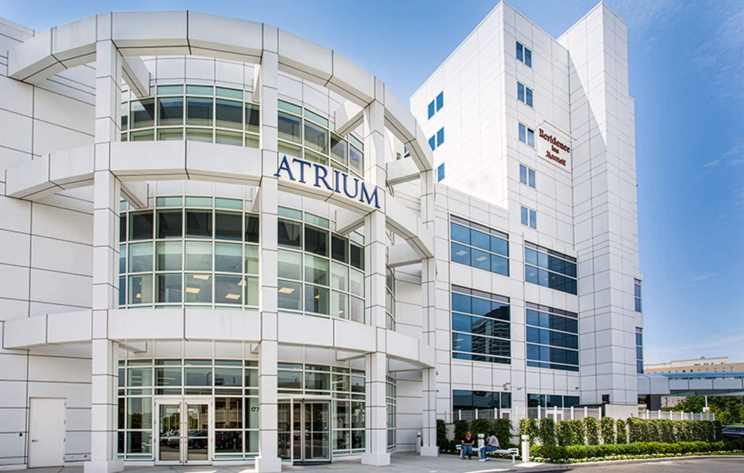 The soaring glass enclosed front entrance of the Metro Center Atrium's office complex in the Bronx