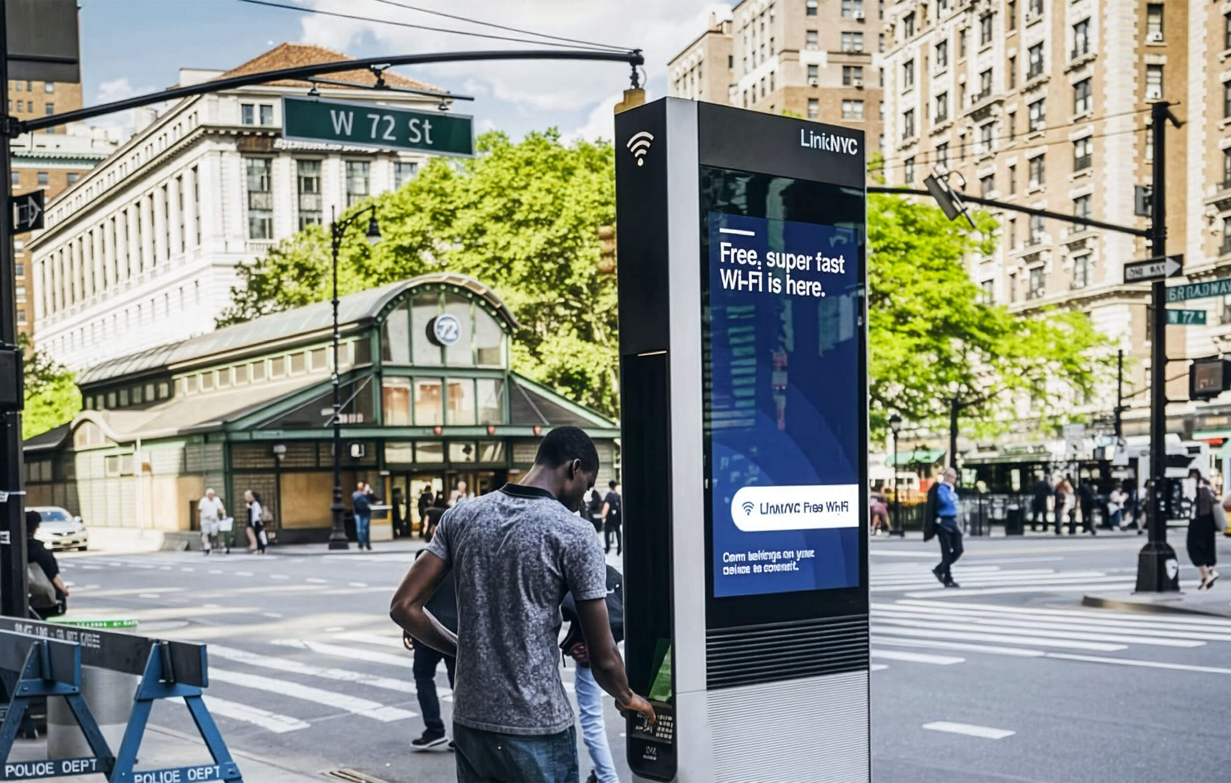 A man using a LinkNYC kiosk