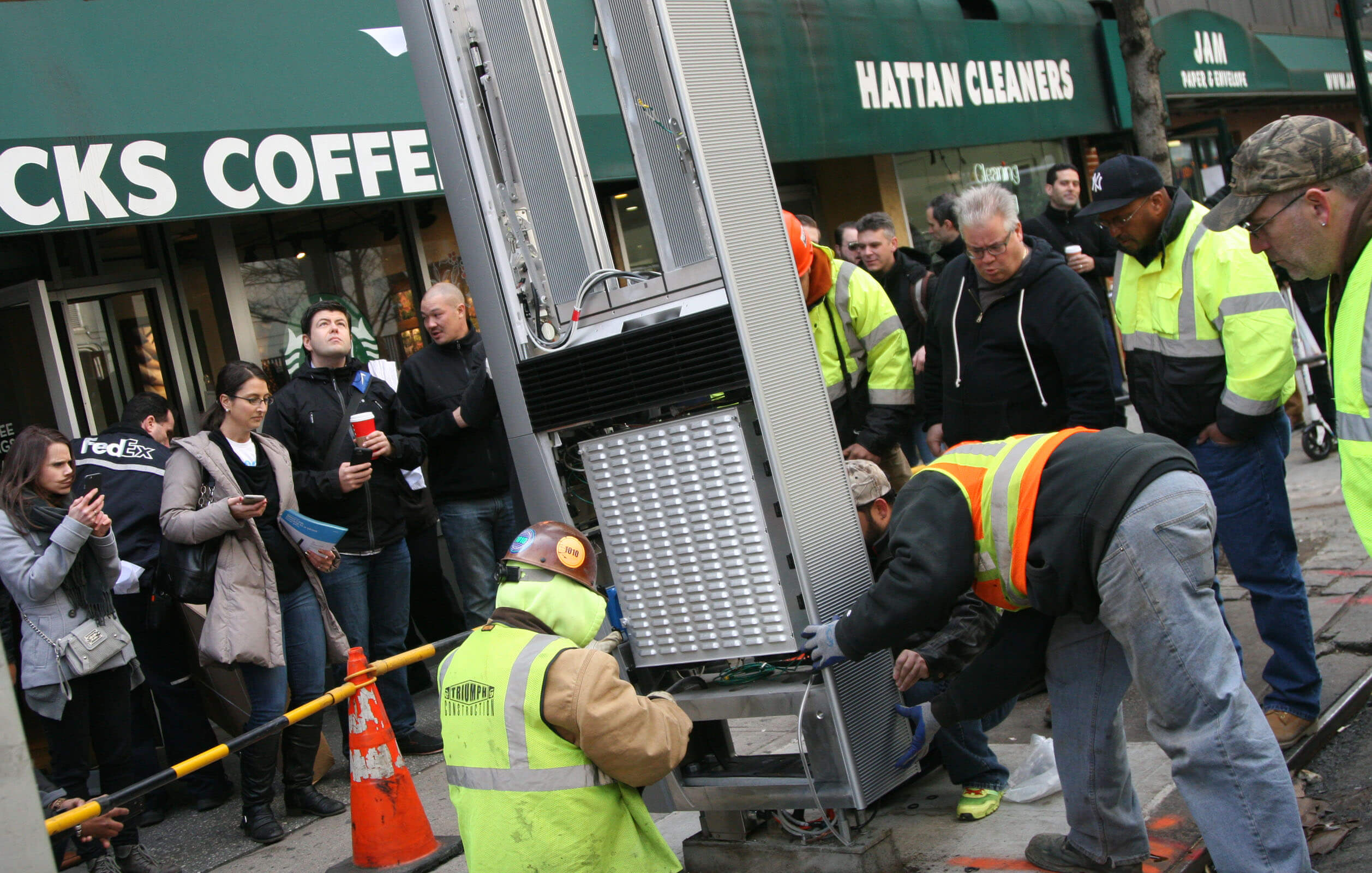 Construction crews installing the first LinkNYC kiosk
