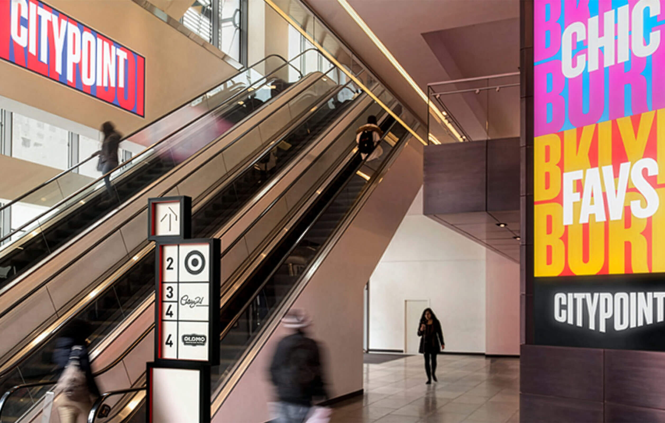 Escalators taking people to the second floor of the City Point mall